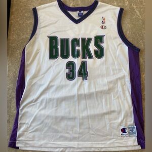 3 Vintage Milwaukee Bucks Jerseys and 1 Vintage Green Bay Packer Jersey.